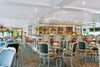 Dining area with tables, chairs, and a bar in a restaurant setting. S.S. Catherine