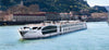 Cruise ship on a body of water with a cityscape in the background. S.S. Catherine