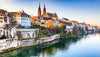 Cityscape with historic buildings and a river, likely in Europe