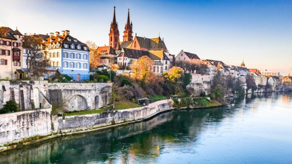 Cityscape with historic buildings and a river, likely in Europe