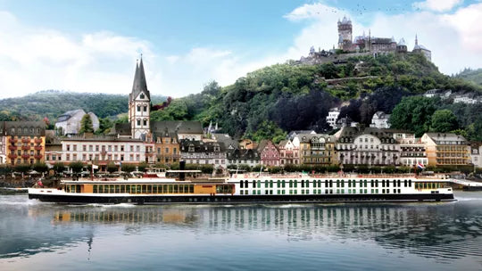 River cruise ship on a river with a town and castle in the background