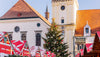 Christmas market with a large decorated tree in front of a historic building