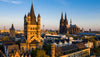 Cityscape with prominent Gothic architecture against a blue sky