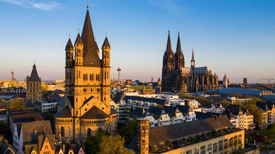 Cityscape with prominent Gothic architecture against a blue sky