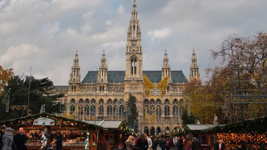 Historic building with Christmas market stalls in front, Vienna, Austria