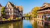 Canal with half-timbered houses on both sides in a picturesque European town.